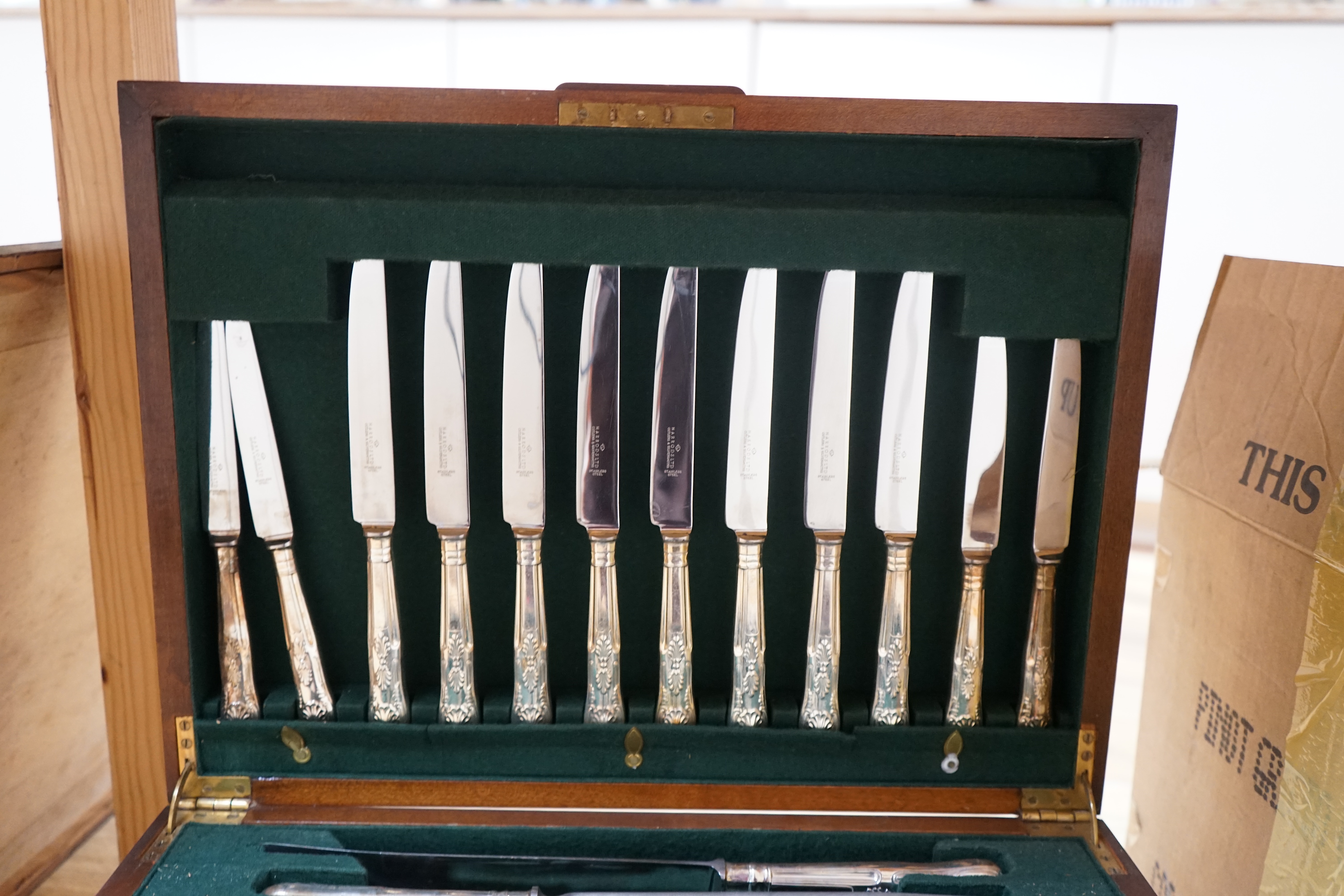 A walnut cased canteen of cutlery with drawer, retailed by Harrods. Condition - one dessert spoon missing